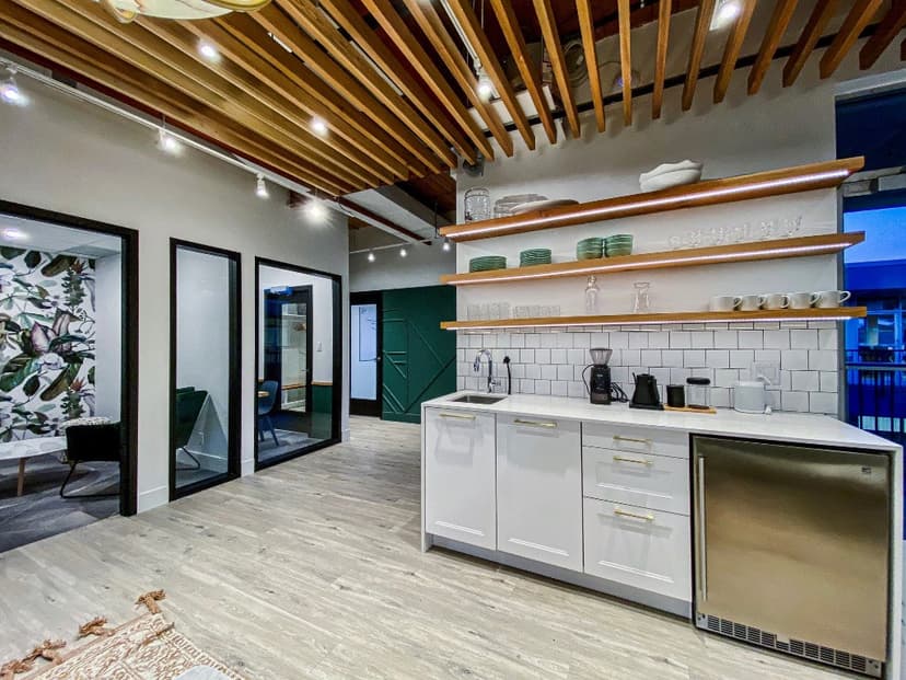 Modern office kitchenette with glass meeting rooms